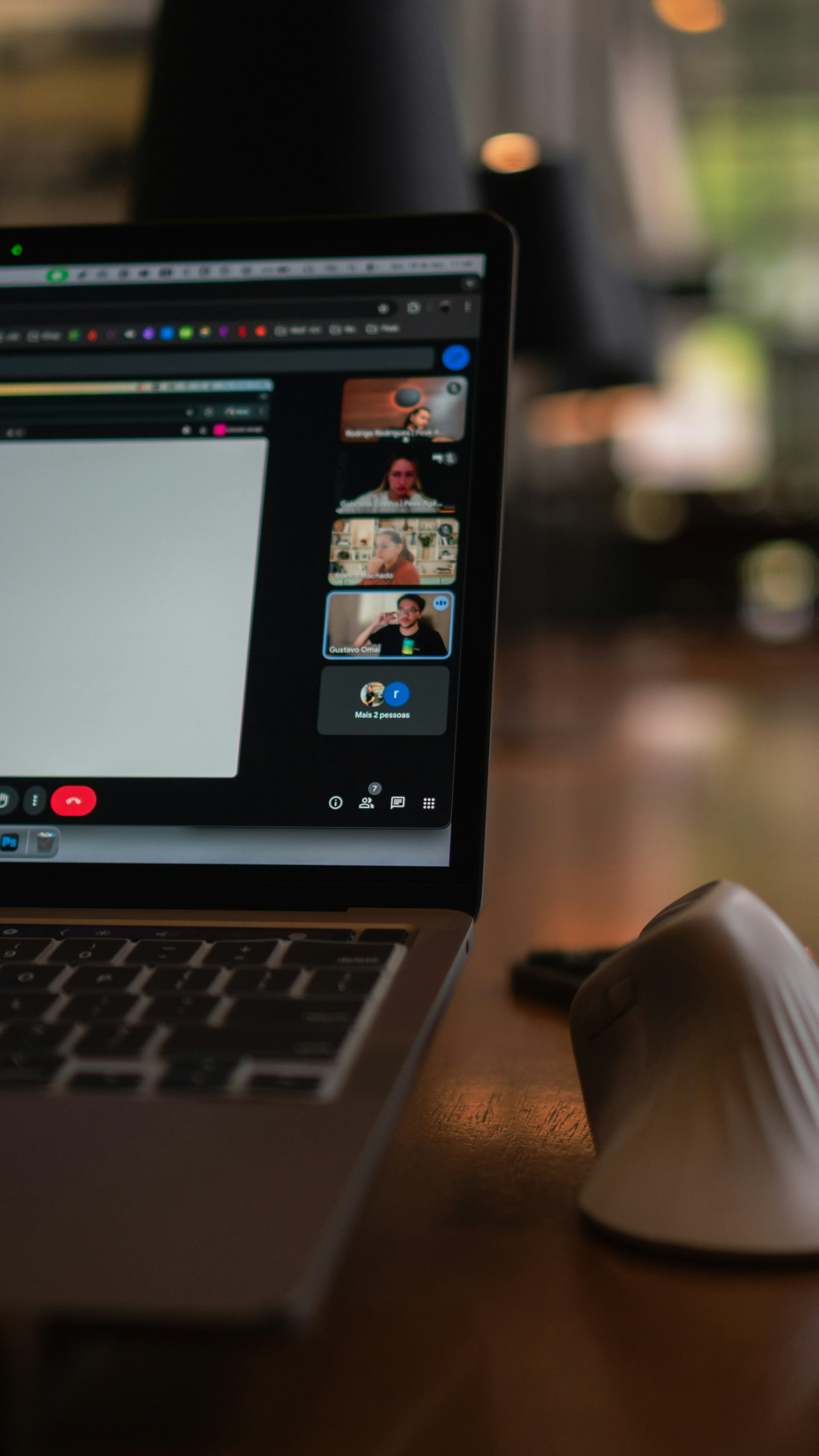 A laptop screen showing a video conference with multiple participants during a remote project kickoff.